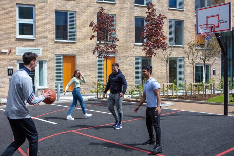 Four people playing basketball