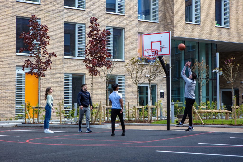 Four people playing basketball
