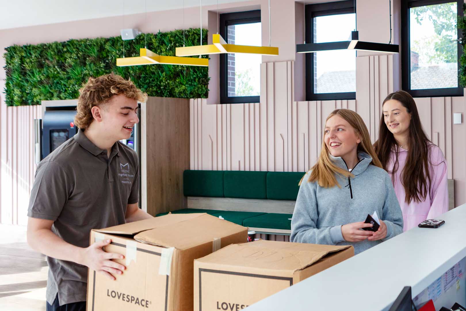 Highfield-House-Team-member-helping-young-resident-move-in.jpg