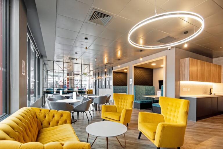 A comfortable social area with bright yellow chairs.