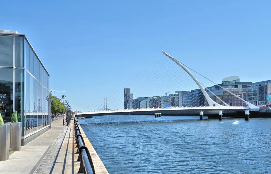 The river Liffey in Dublin. The Samuel Beckett Bridge is visible, stretching across the river.