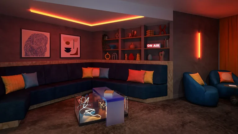 A social space in Ironworks. It's a dark room with fancy lighting. There is a large sofa. It looks comfortable.